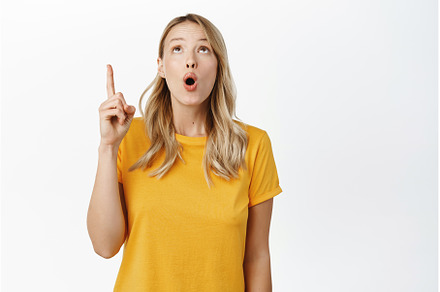 Amazed blond girl showing