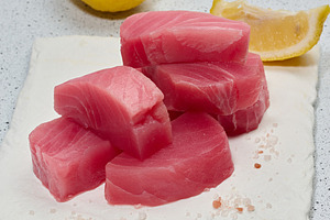 A stack of raw tuna pieces on a white board, a Food & Drink Photo by ndanko