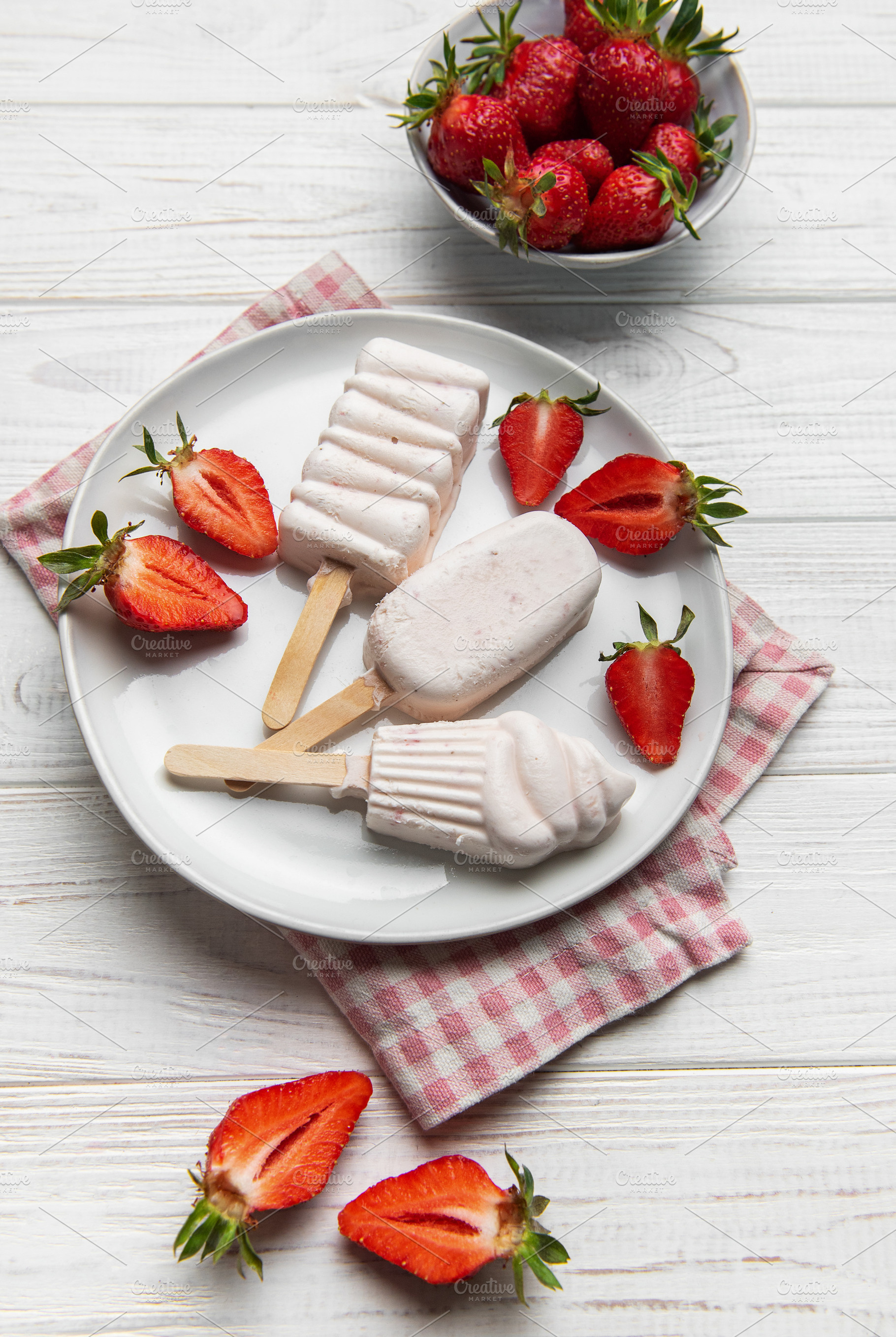 Homemade strawberry ice cream popsicles with fresh fruit, a Food & Drink Photo by Olena Rudo