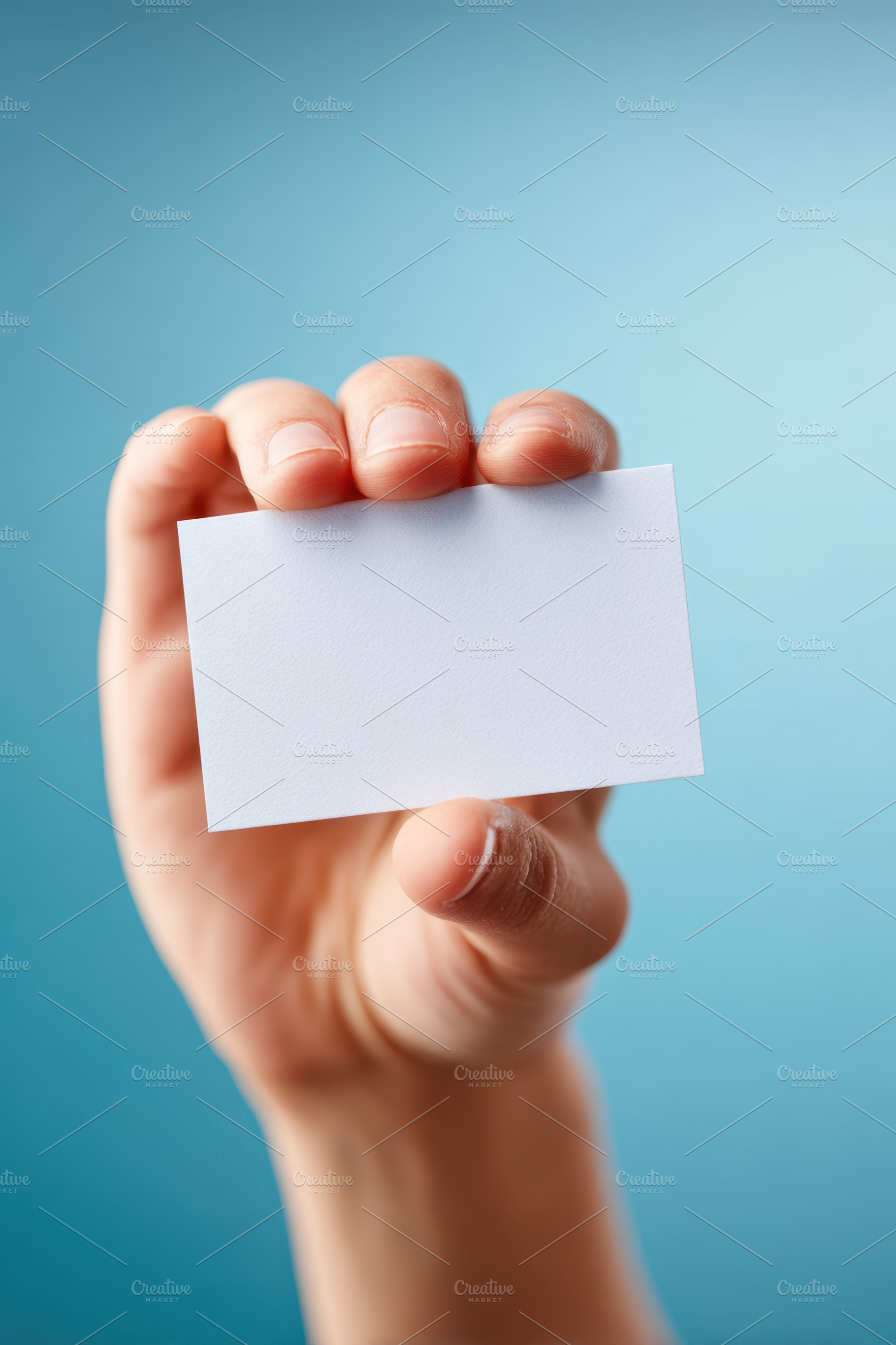 Hand holding a blank card against a blue background, a Background Photo by AlyaAnd