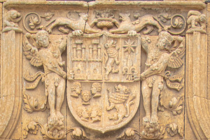 Historic stone coat of arms on architectural facade, a Photo by DanFLCreativo