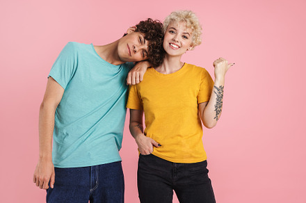 Cheerful young teenage couple poointing, a Person Photo by Dean Drobot