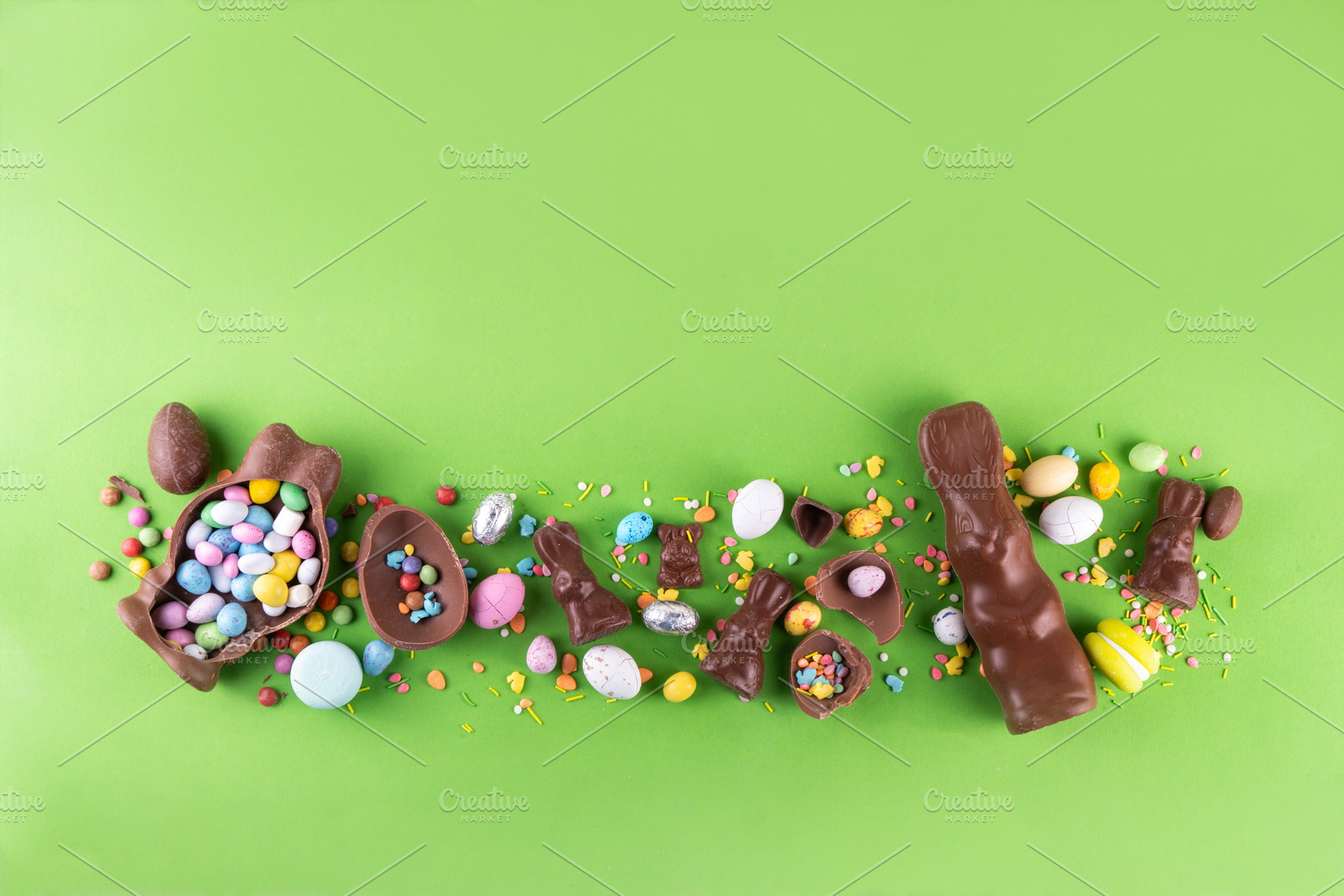 Easter eggs, bunny and rabbits on bright green background, a Holiday Photo by Rimma