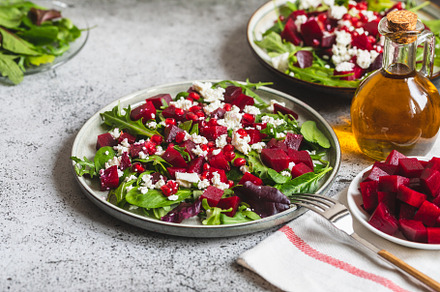 Arugula, Beet and cheese salad with pomegranate and dressing on, a Food & Drink Photo by Ivanna