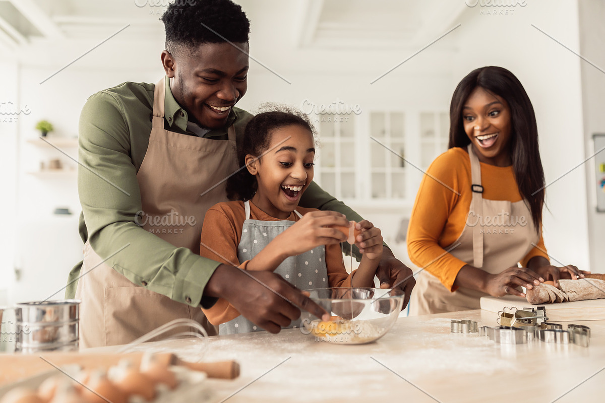 Cheerful Black Family Cooking Making Vegetable Salad In Modern Kitchen, a Photo by Prostock-Studio (Photo 2 of 2)