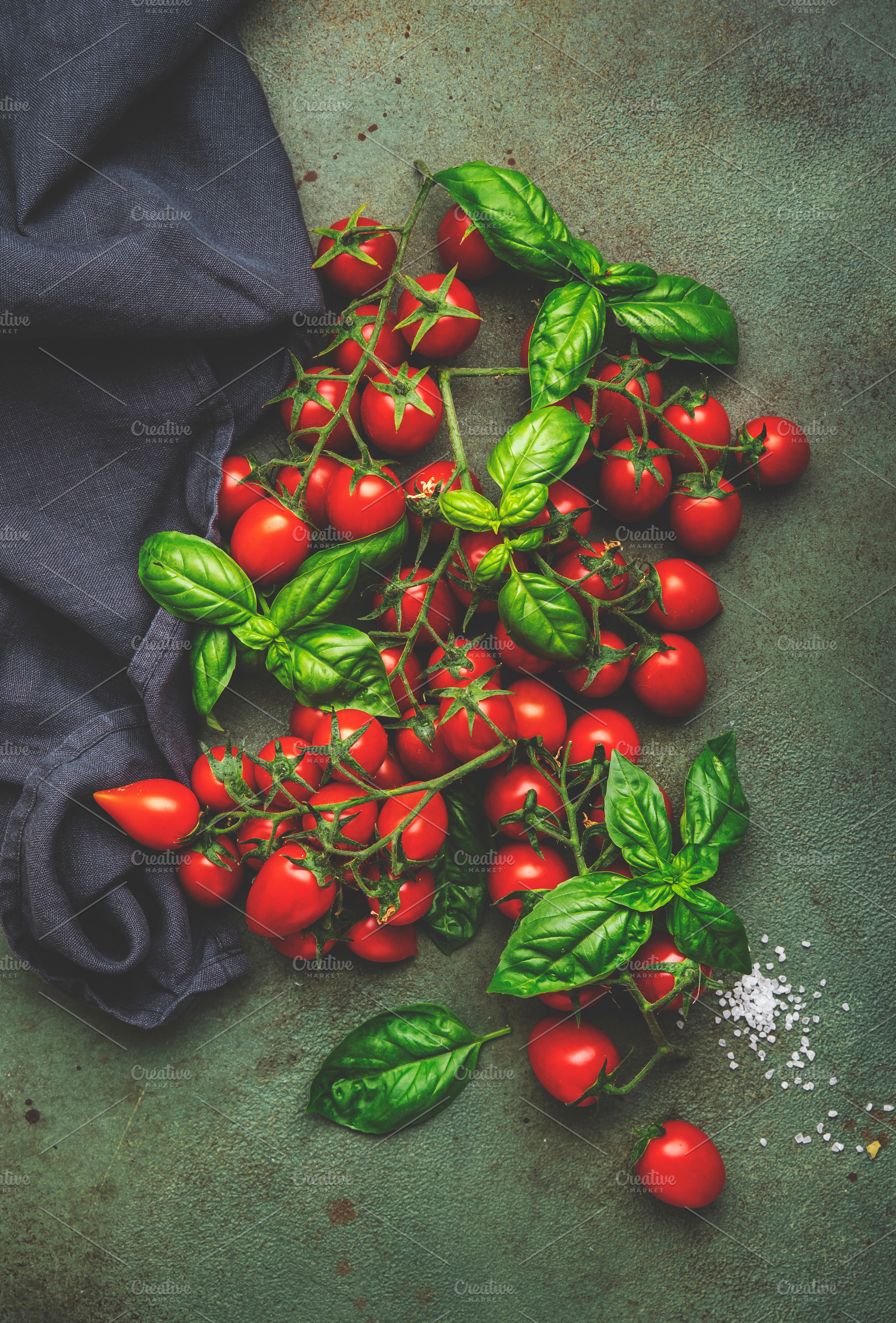 Red cherry tomatoes on branches with green basil and sea salt on, a Food & Drink Photo by 5PH