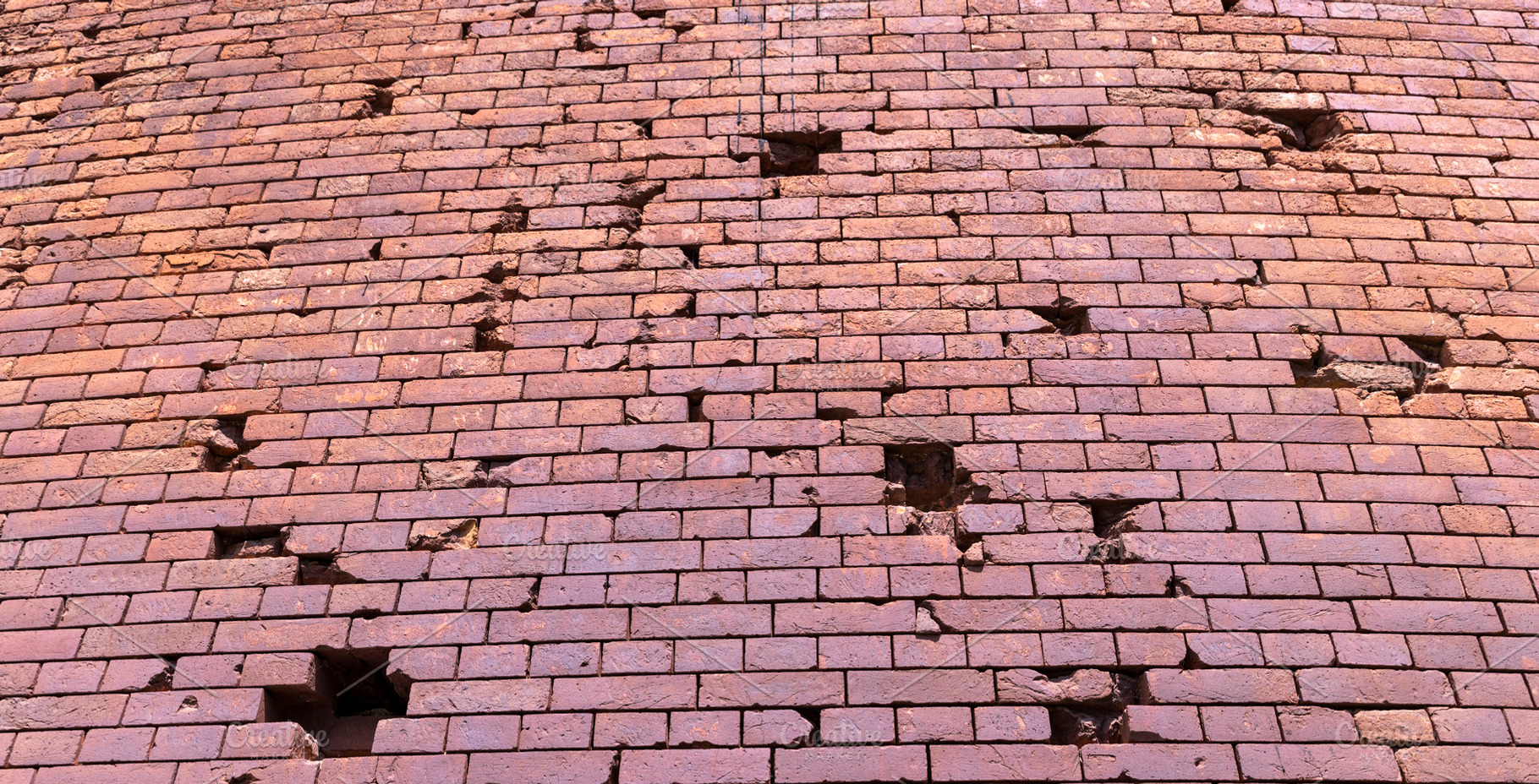 An old brick wall with various damages, a Photo by rsoollAI