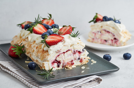 Strawberry meringue pavlova roll with cream and fresh seasonal berries, a Food & Drink Photo by Foodie's Shop