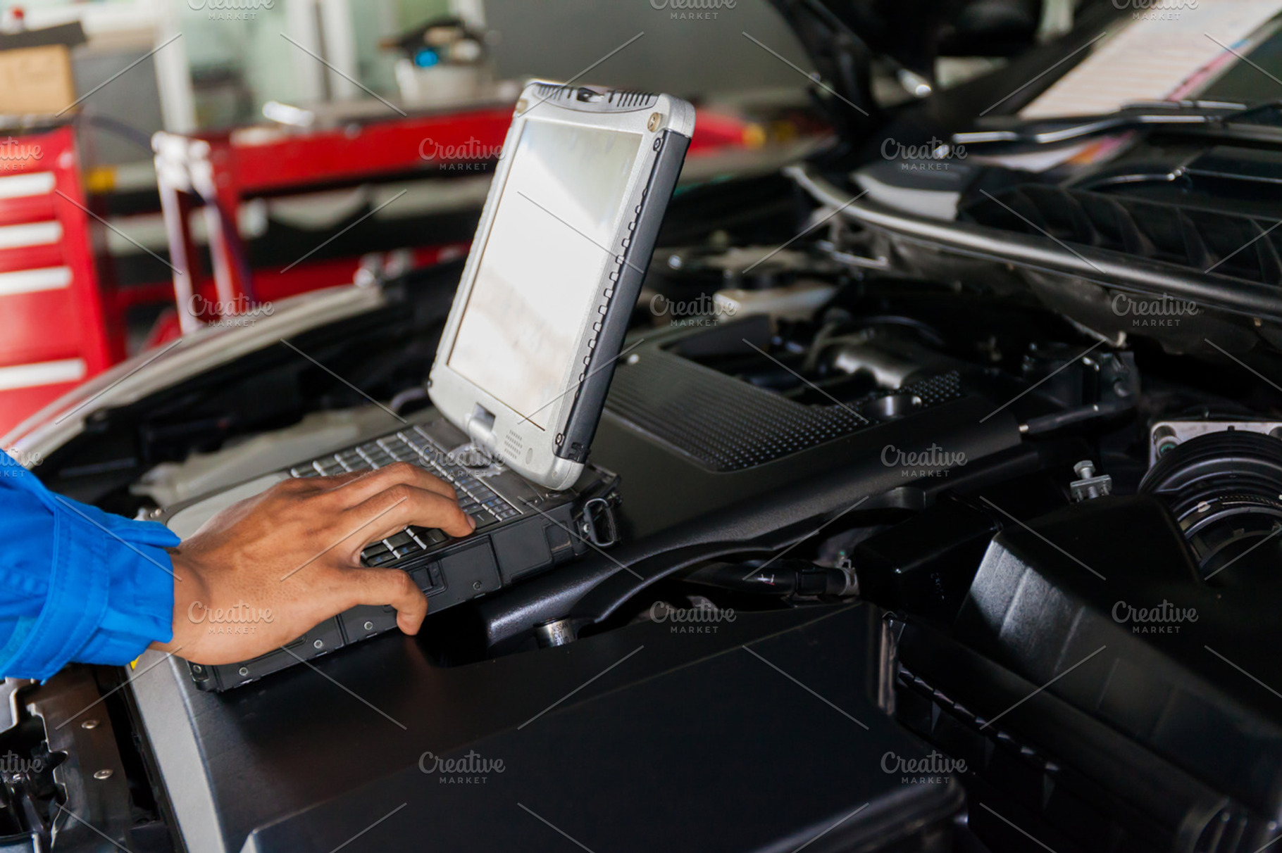 Mechanic using Diagnostic machine tools ready to be used with car, a Transportation Photo by Twinster Photo
