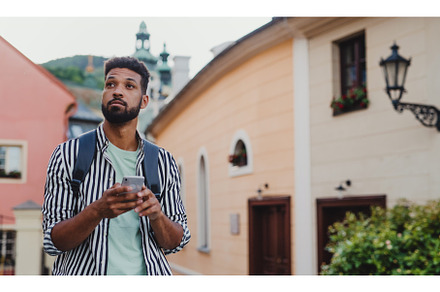 Young man outdoors on trip in town, a Person Photo by HalfPoint