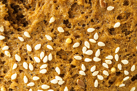 Close detailed macro view of wholesome whole grain bread texture showing the po