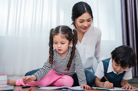 Mother teaching children in drawing class. Daughter and son pain, a Person Photo by Ministocker