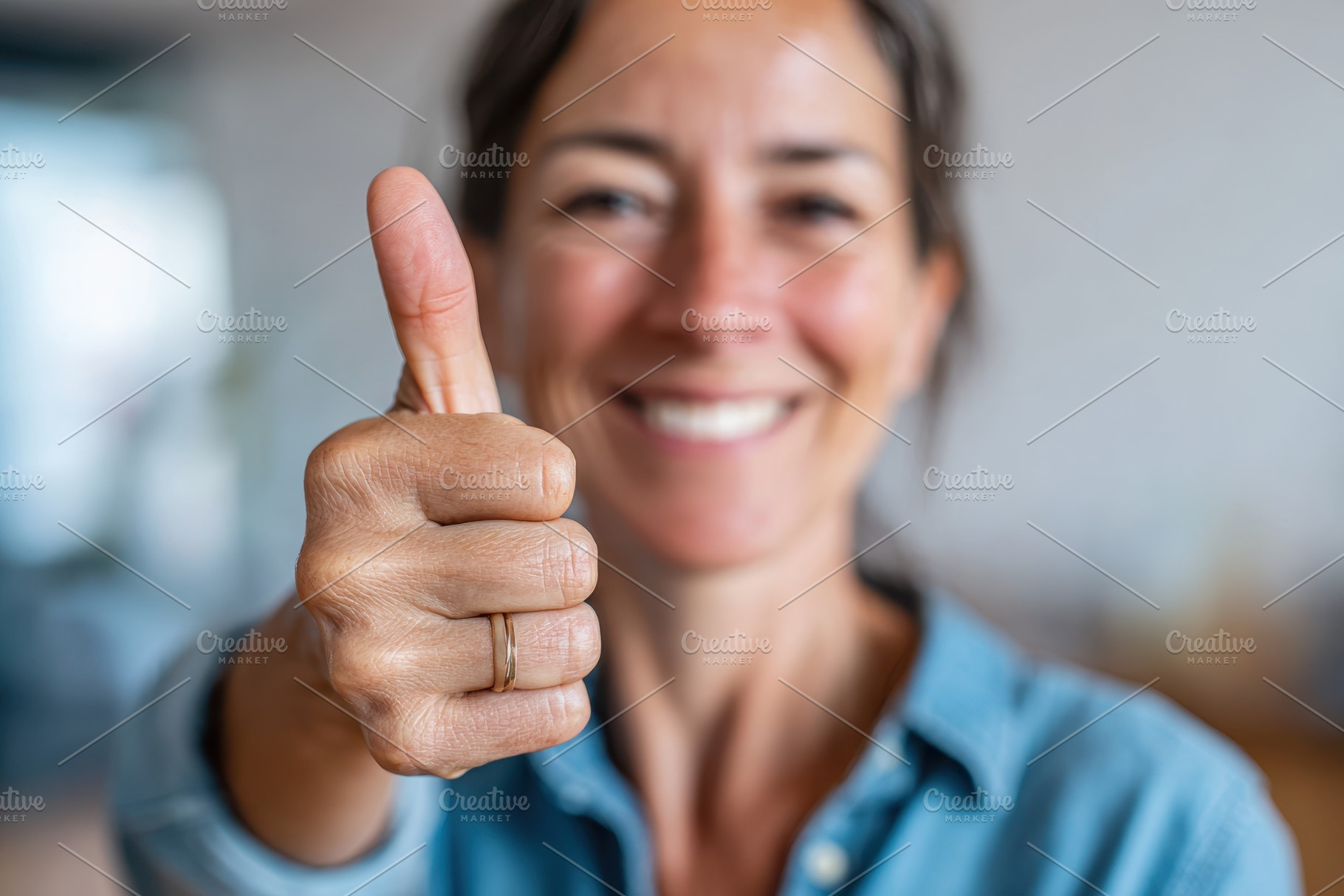 Woman giving thumbs up in bright indoor setting, a Person Photo by AlyaAnd