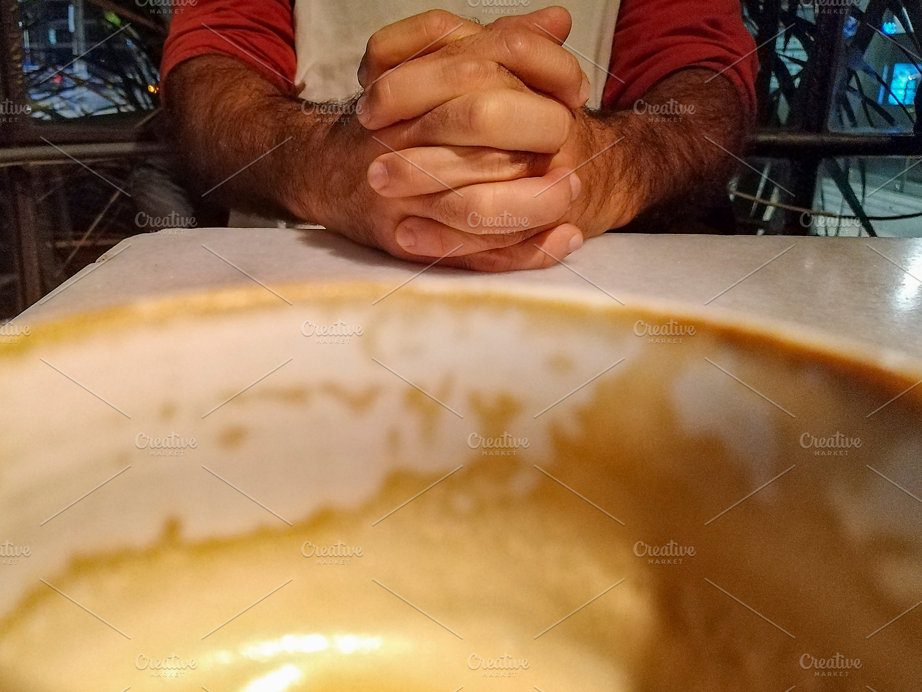 Man folded hands over plate with leftover soup, a Food & Drink Photo by DanFLCreativo