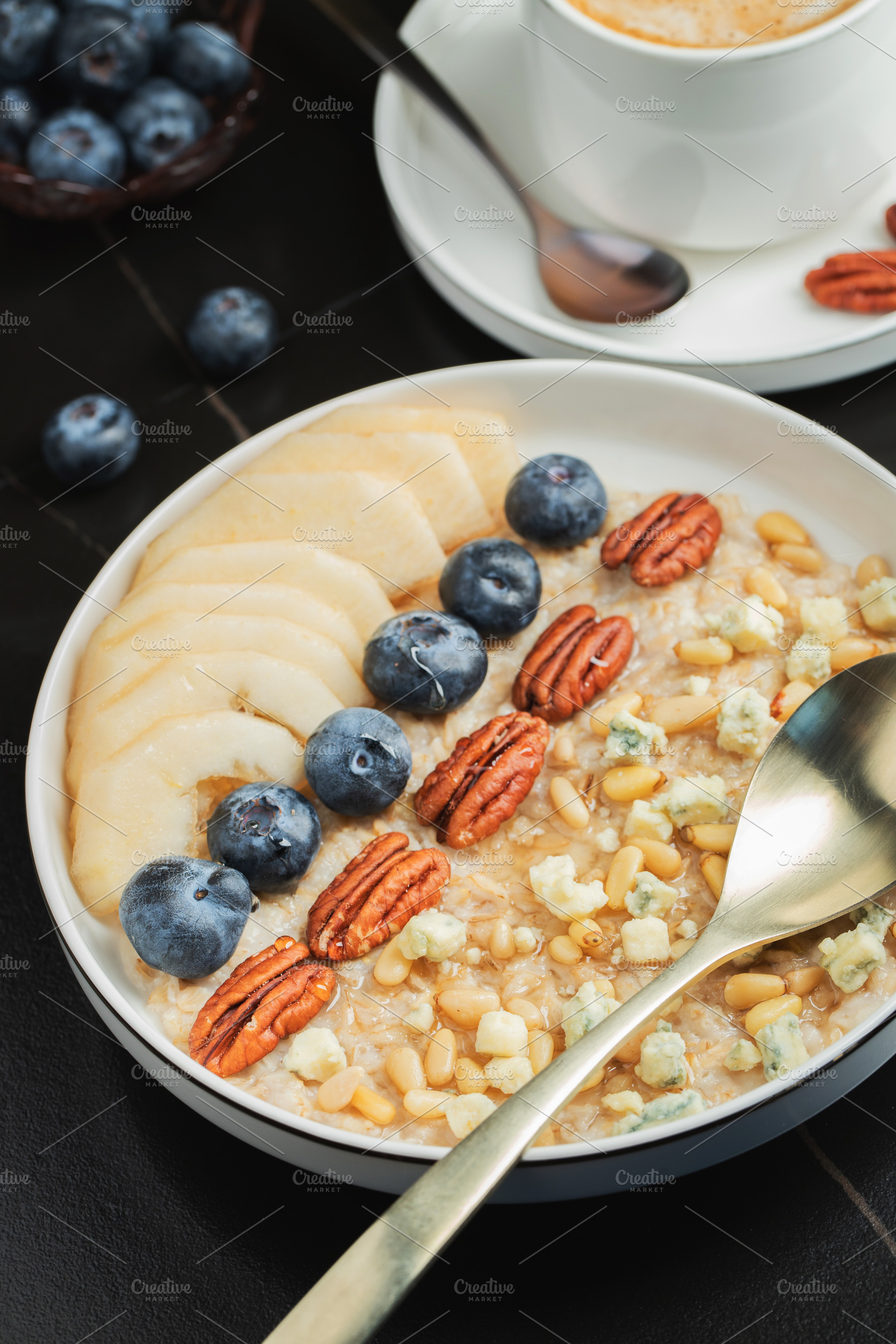 Oatmeal. Bowl of oatmeal porridge with blackberry, bananas and chia seeds on gr, a Food & Drink Photo by Budarinphoto