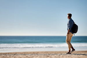 Young man with a backpack standing, a Person Photo by MistyDay