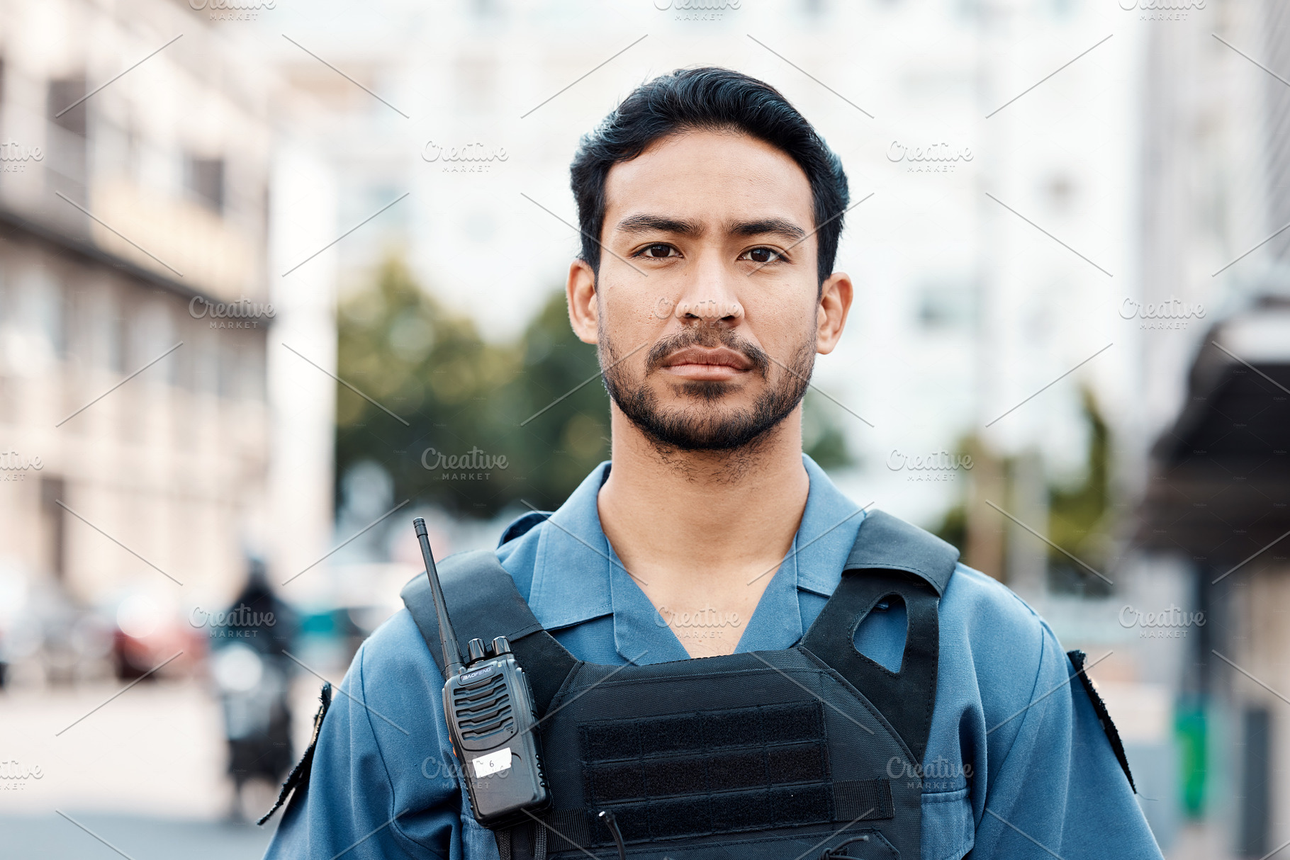 Portrait, ready or policeman in city for law enforcement, security protection or street safety. Face of cop, walkie talkie or serious Asian security guard on patrol in urban town for crime or justice, a Photo by Peopleimages.com