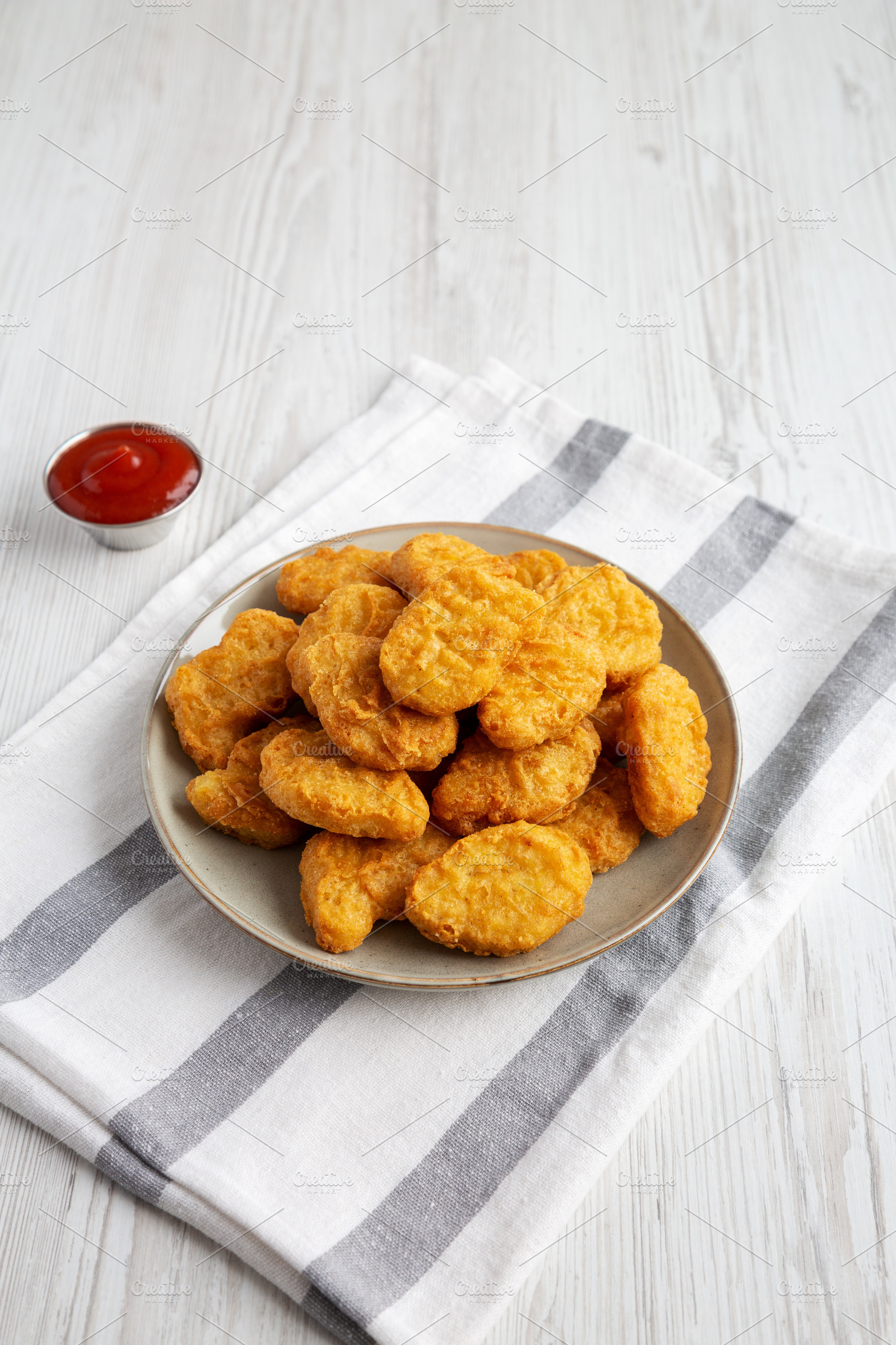 Homemade Chicken Nuggets with Ketchup, side view., a Food & Drink Photo by LiudmylaChuhunova