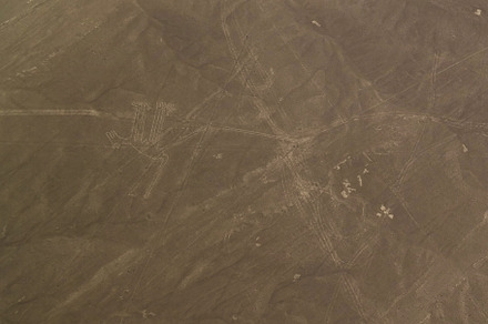 Aerial airplane panoramic view to Nazca geoglyph lines aka Dog, Ica, Peru
