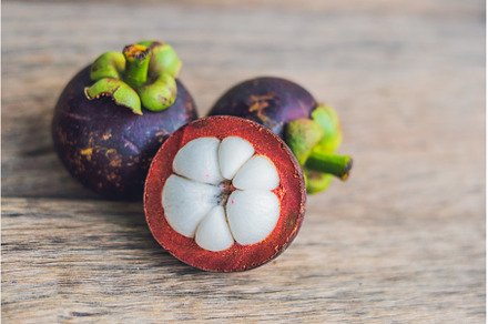 Mangosteen fruit on wood table, a Food & Drink Photo by Elizaveta Galitskaya
