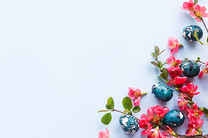 Easter flat lay. Stylish easter eggs and red flowers on blue bac, a Holiday Photo by Sonjachni