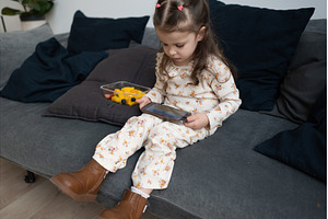 Girl sits alone on sofa at home, an Architecture Photo by undrey