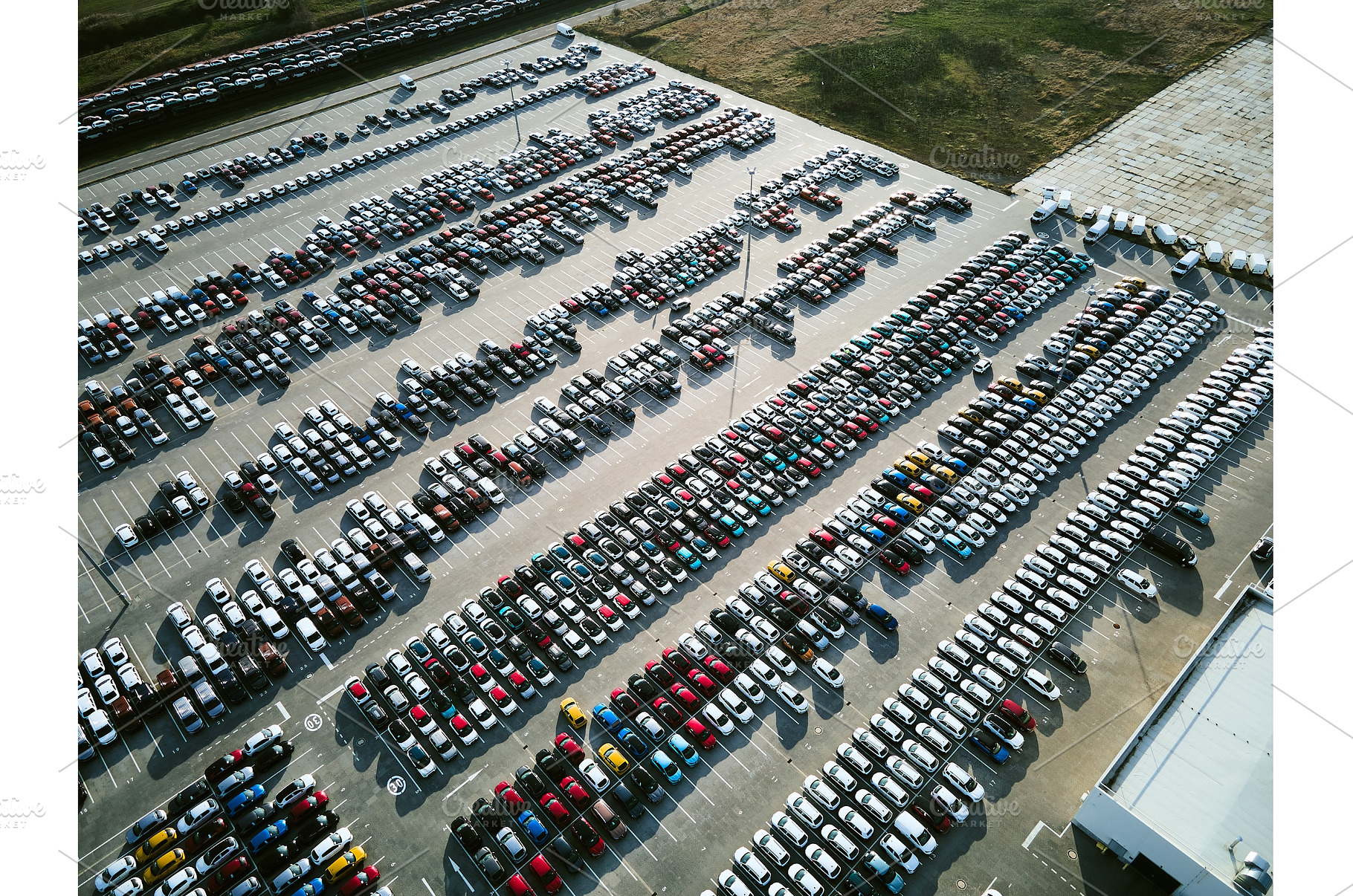 Aerial view of a massive parking lot, an Industrial Photo by HalfPoint