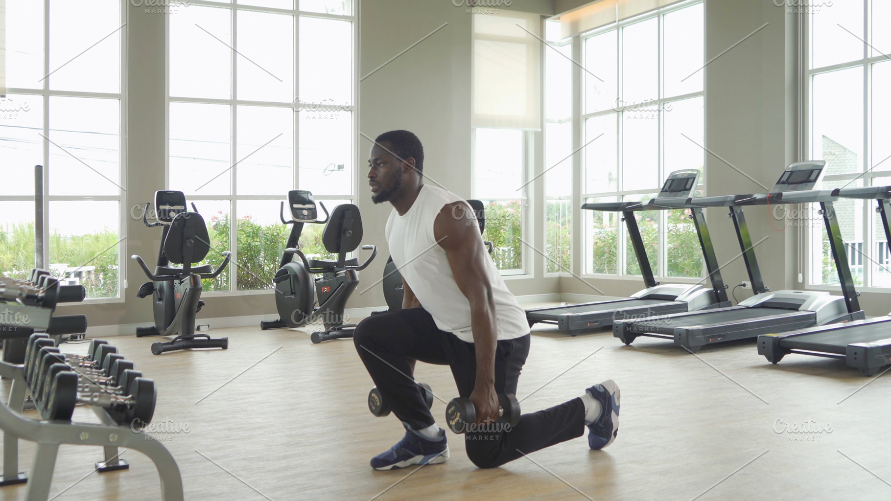 Portrait of strong black african american man using fitness equi, a Photo by Tampatra