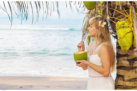Girl on the beach drinks coconut, a Person Photo by yanadjana