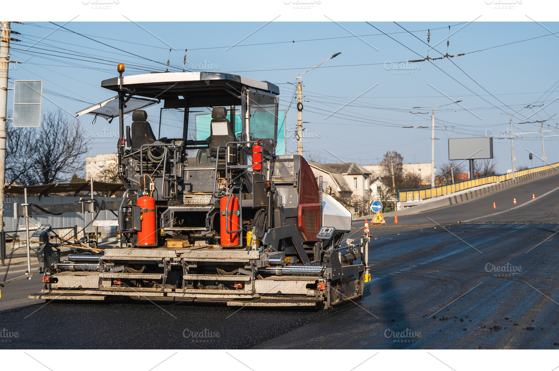 Modern asphalt paver machine working, an Industrial Photo by volodymyrshtun13795