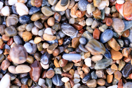 Background of colored sea pebbles on the beach of Alanya, Turkey, an Abstract Photo by TanaCh