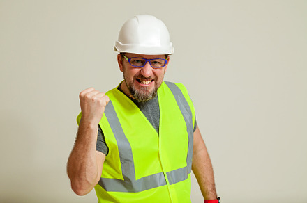 worker in a vest and white helmet, a Person Photo by Photostock