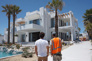 Men walk toward new white building, a Photo by Beautiful things