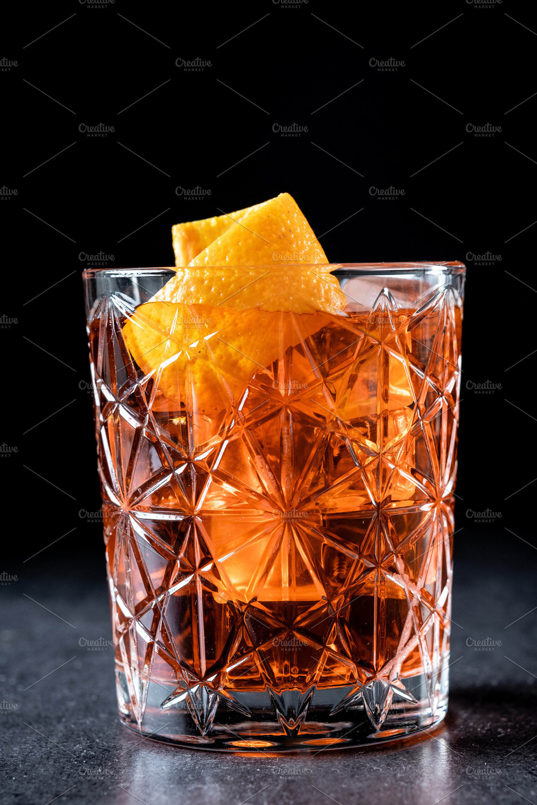 Americano cocktail garnished with twist orange on wooden table, a Food & Drink Photo by etorres69
