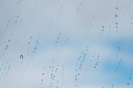 Raindrops on a window against the sky, an Abstract Photo by rubenchase