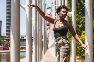Woman Posing Among Flagpoles, a Person Photo by SkyNext