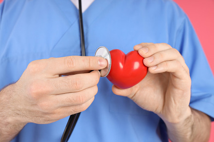 Nurse man holds red heart, close up, a Person Photo by AtlasStudio PRO