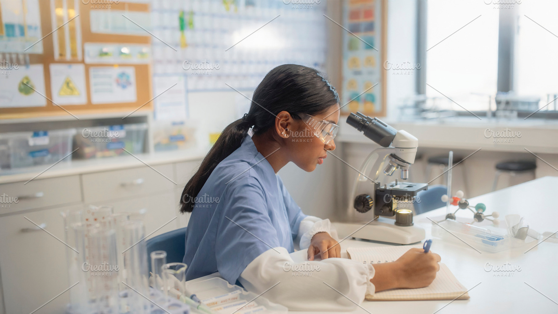 Black teenager student working at laboratory tools and science c, a School & Education Photo by DanFLCreativo
