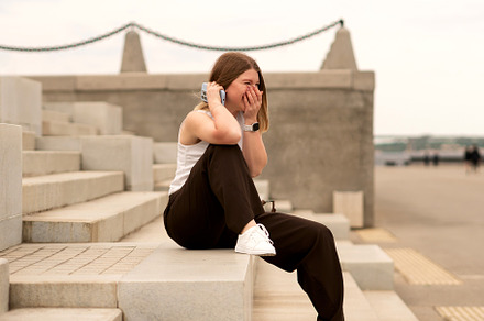 Young woman sitting on stone steps