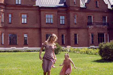 funny family mom and daughter in pink dresses running through a green meadow ag, a Person Photo by SaulichPhoto