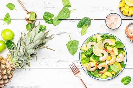 Fresh pineapple salad with shrimps, spinach, avocado and lime on, a Food & Drink Photo by 5PH