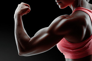 Athlete showcasing arm anatomy in a dynamic side pose against a dark background, a Sports & Recreation Photo by AlyaAnd