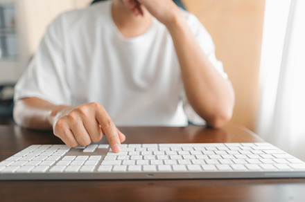 Man working at home, hands pressing computer keyboard, working a, a Business Photo by Art Rachen