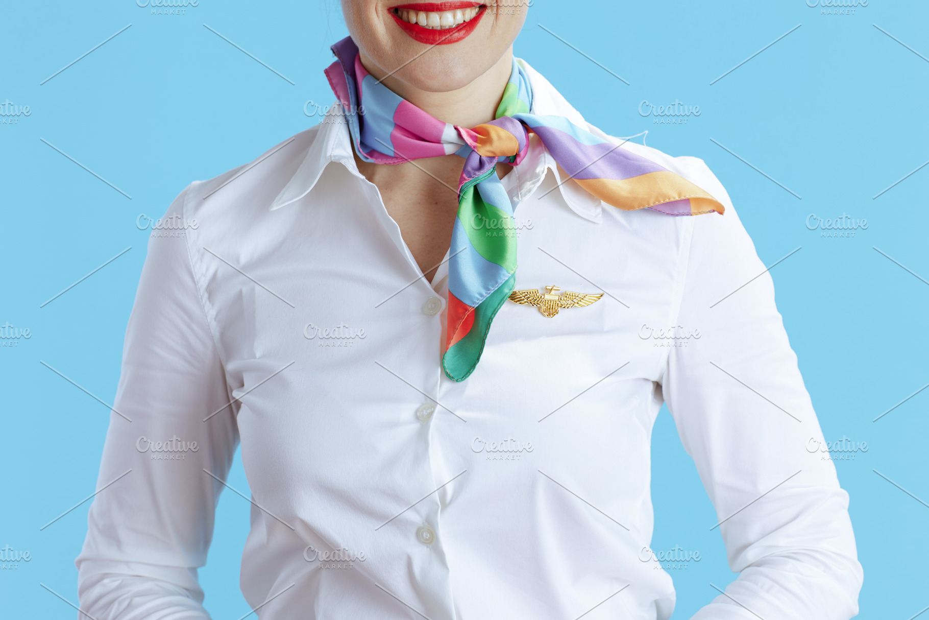 Closeup on smiling stylish female stewardess on blue, a Business Photo by Alliance Images