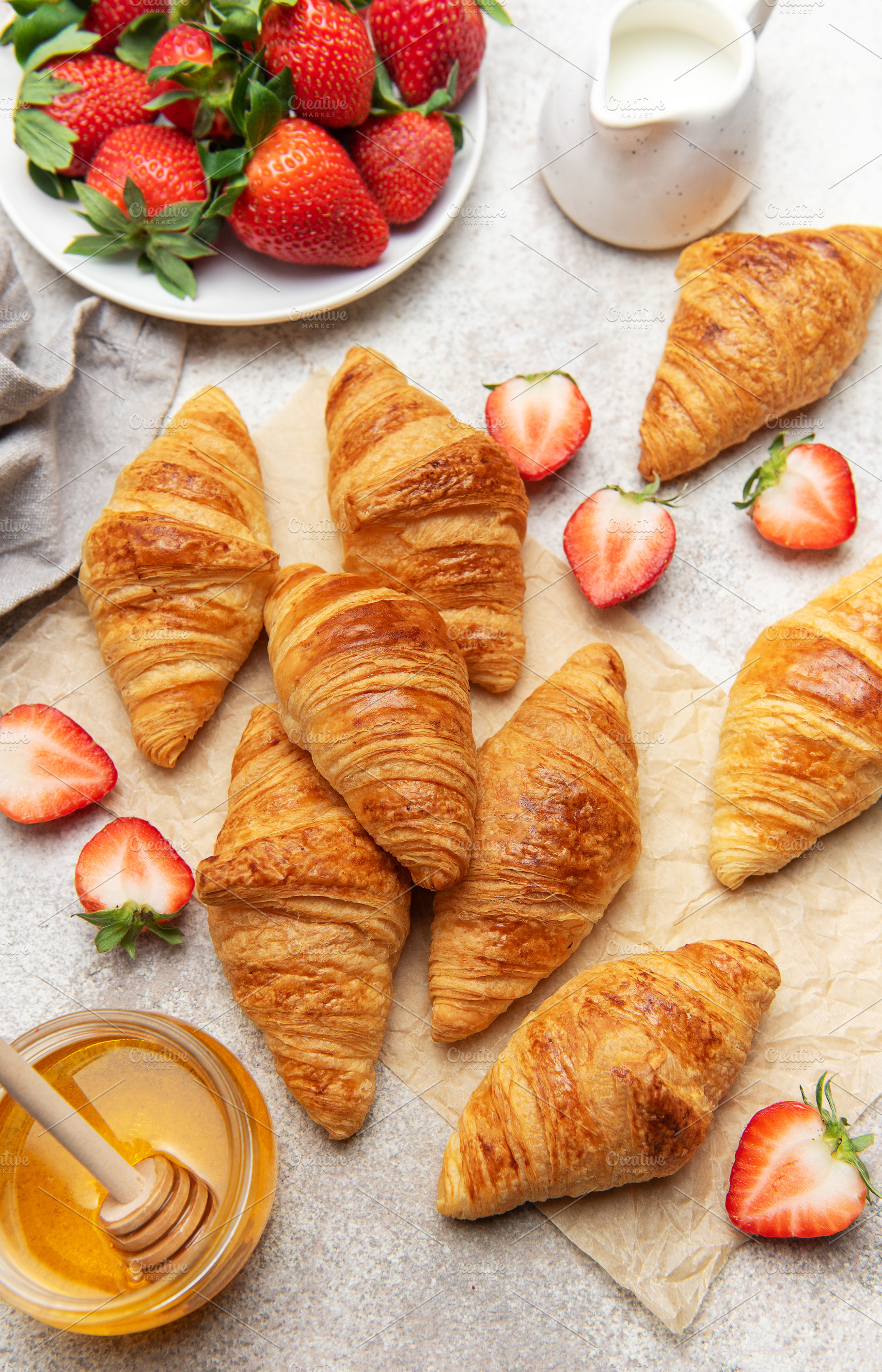 Freshly baked croissants with strawberries and honey for breakfa, a Food & Drink Photo by Olena Rudo
