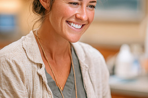 Smiling female dental professional in clinic, a Person Photo by AlyaAnd