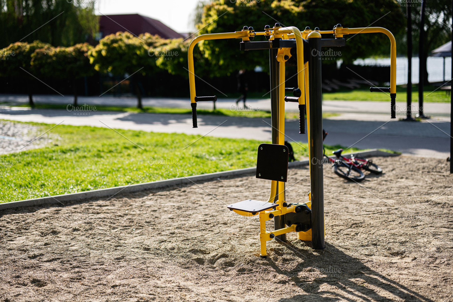 Outdoor gym equipment in a park setting on a sunny day, a Photo by AS photostudio