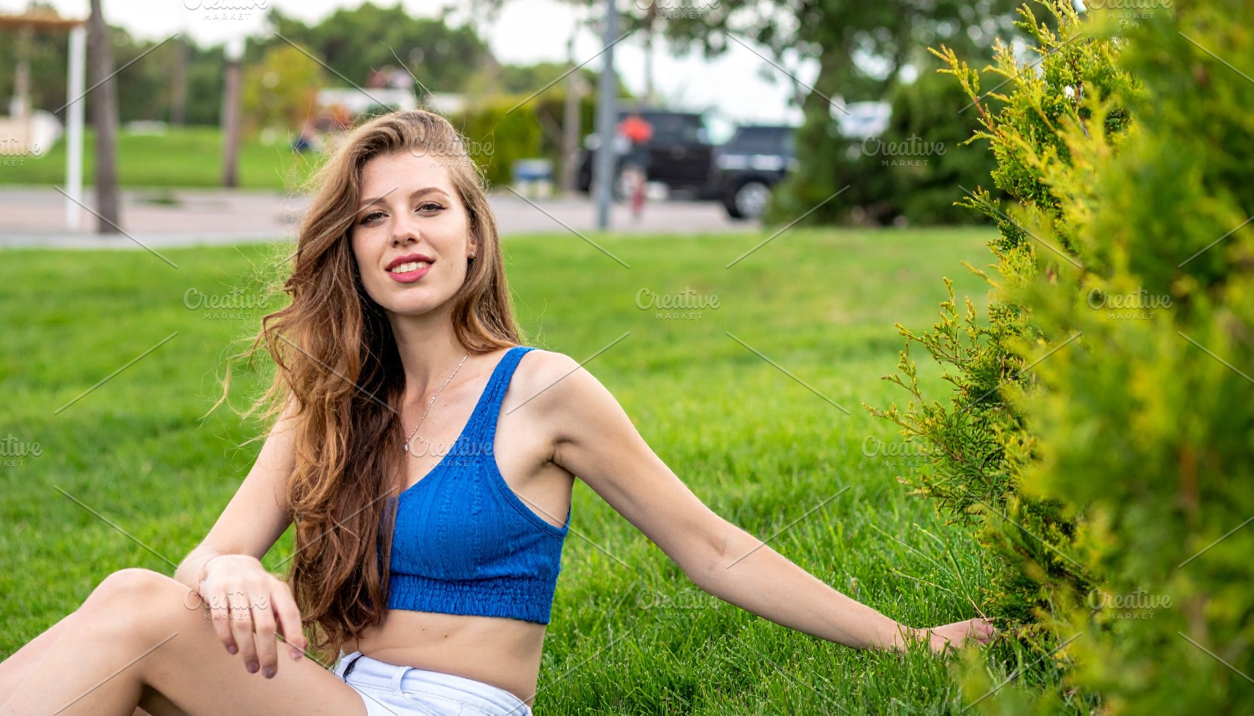 beautiful young woman seated on grass, AI generated, a Photo by WorldOfPhotos