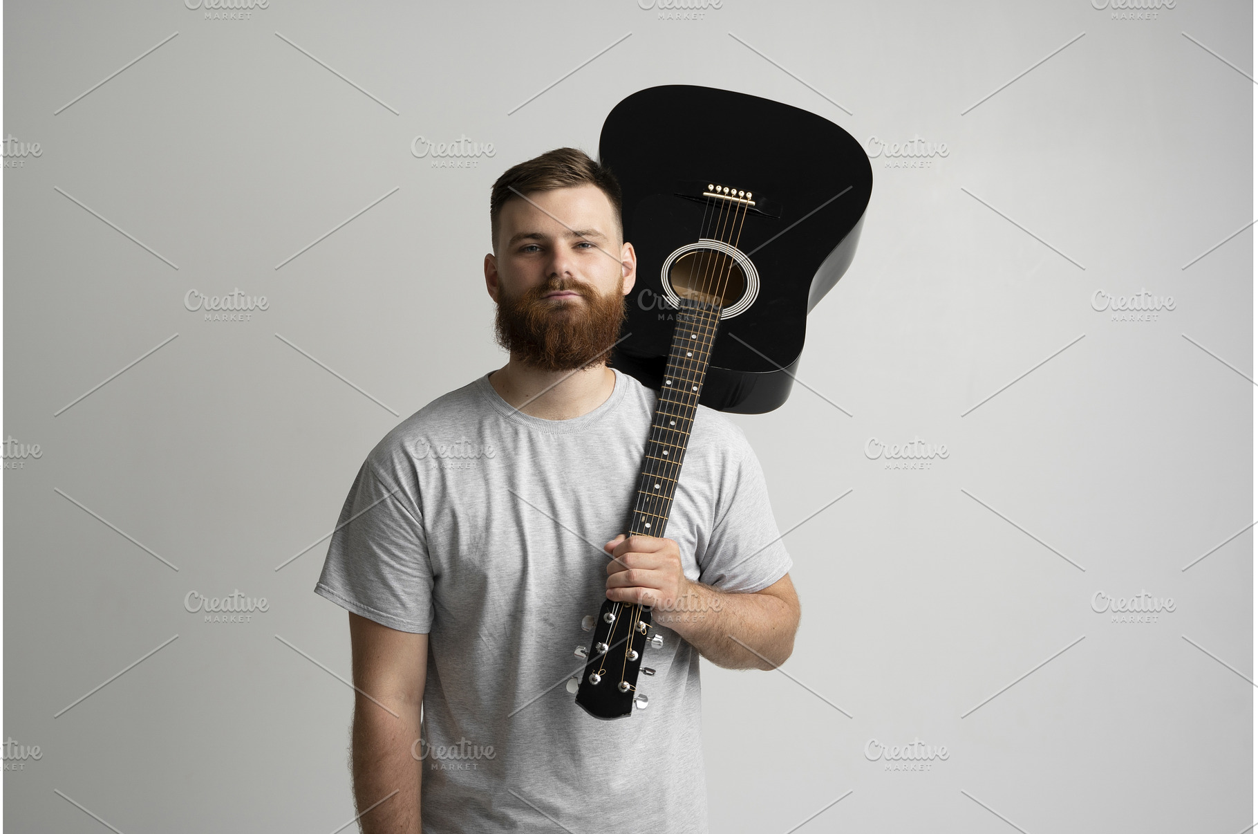 Bearded young man in grey t-shirt, a Person Photo by volodymyrshtun13795