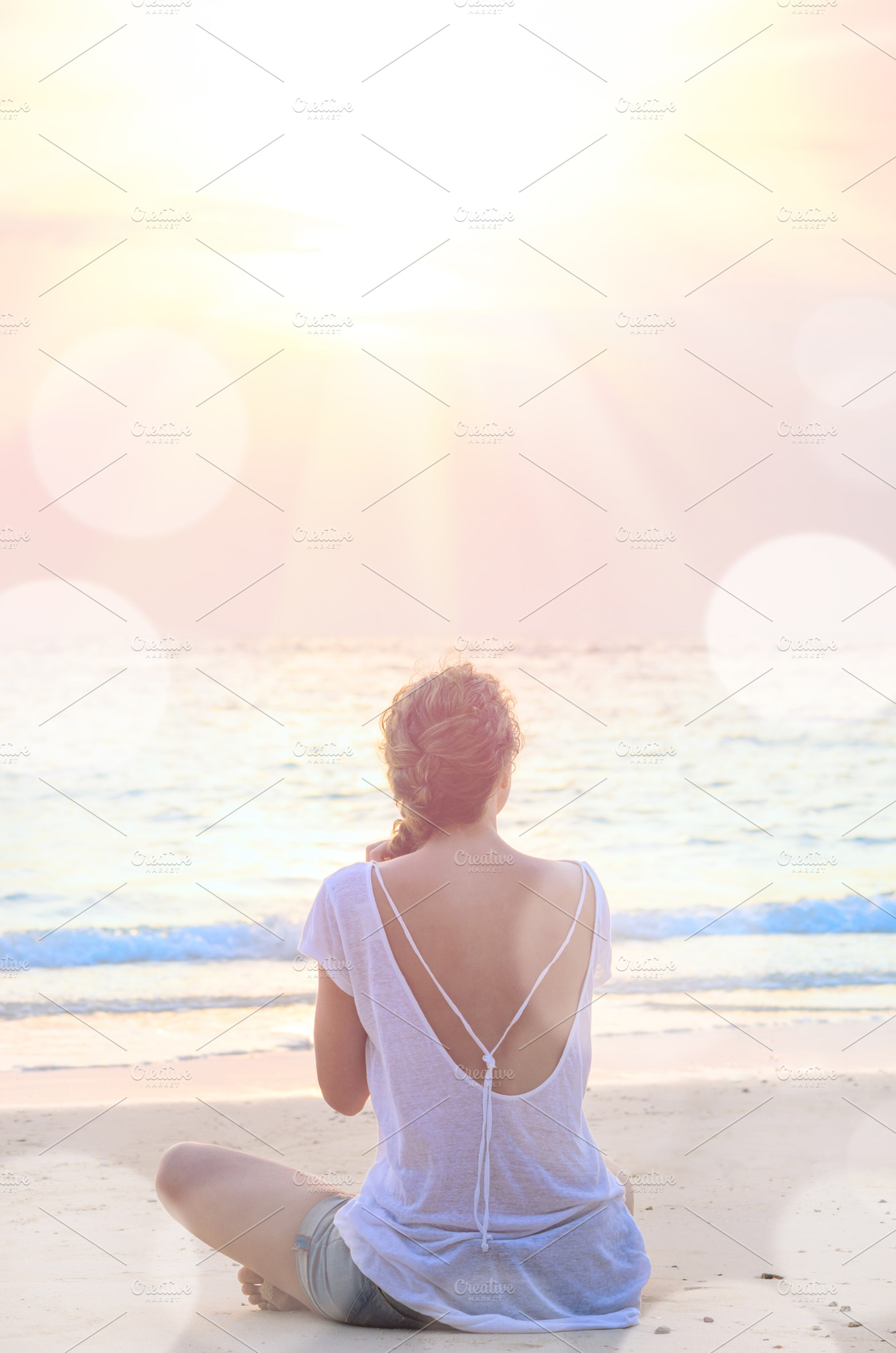 Woman practicing yoga at sunrise beach featuring woman, summer, and beach, a Person Photo by sergeypeterman